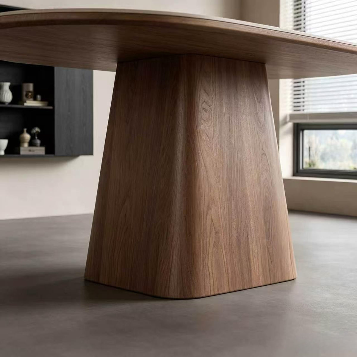 Close-up of the dining table's broad tapered wood-grain pedestal beneath the oval top.