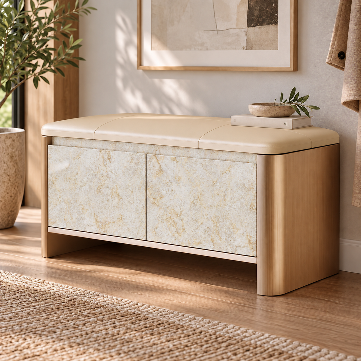 Entryway storage bench with a beige cushion, rounded gold-tone sides and pale beige patterned doors.