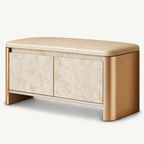 Beige upholstered storage bench with rounded gold-tone sides and two pale beige patterned cabinet doors.