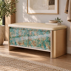 Entryway storage bench with a beige cushion, rounded gold-tone sides and turquoise and brown patterned doors.