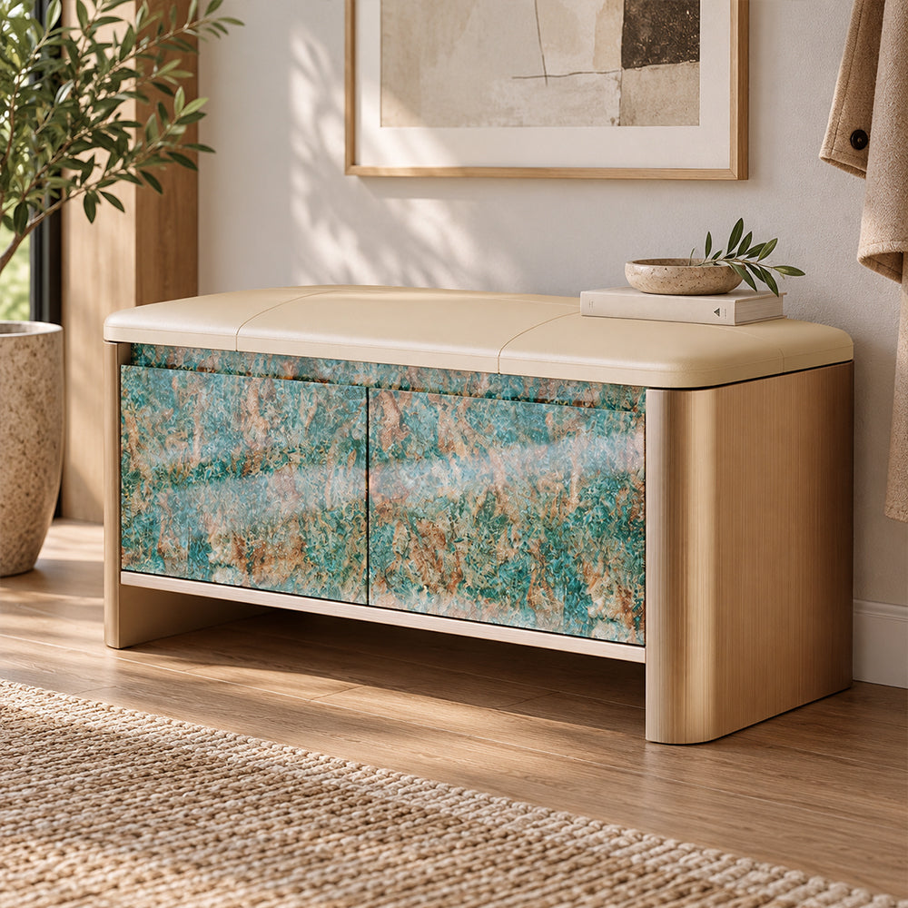 Entryway storage bench with a beige cushion, rounded gold-tone sides and turquoise and brown patterned doors.