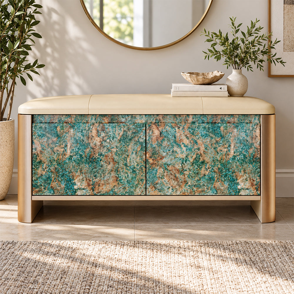 Front view of the storage bench with turquoise and brown patterned doors beneath a beige upholstered seat.