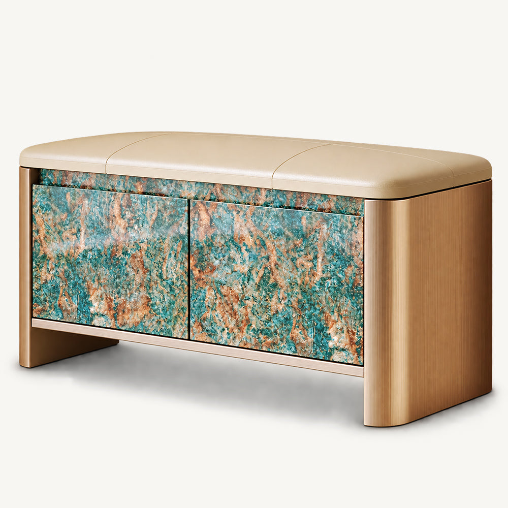 Beige upholstered storage bench with rounded gold-tone sides and two turquoise and brown patterned cabinet doors.