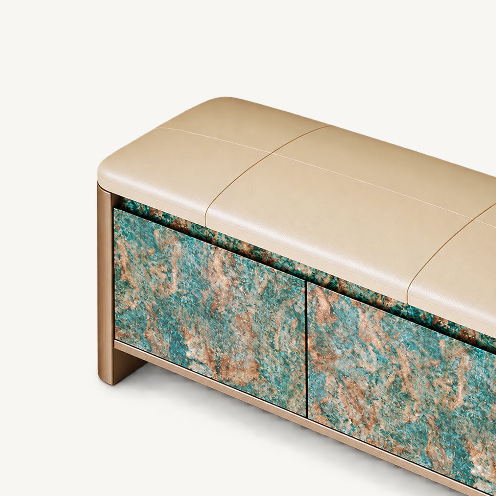 Close-up of the bench's beige stitched cushion and turquoise and brown patterned cabinet front.