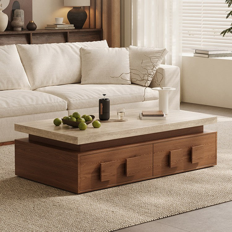 Rectangular coffee table with a pale top and brown drawer base, styled in front of a cream sofa.
