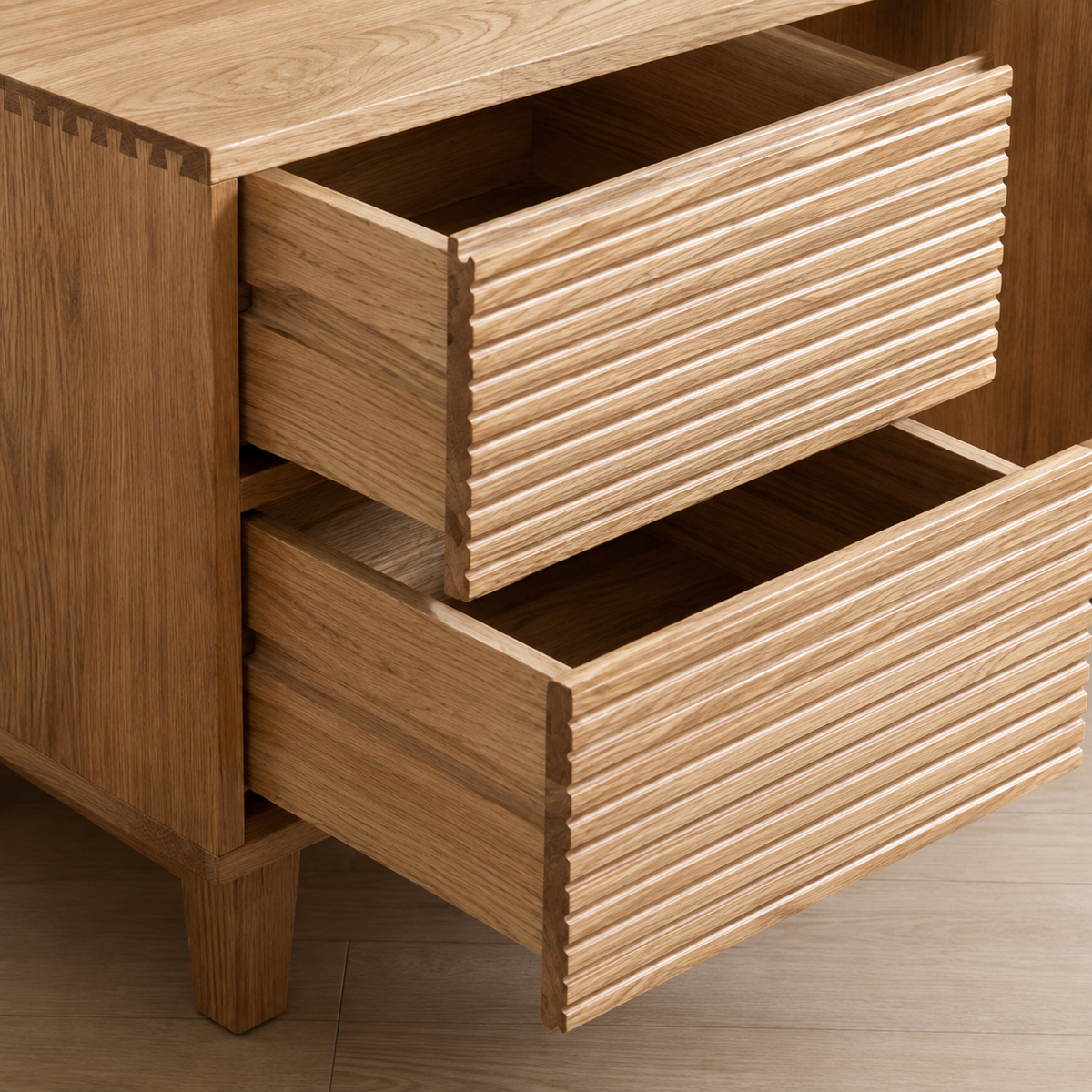 Two open drawers with horizontally ribbed fronts on the light wood-tone TV stand.