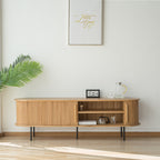 Light wood-tone TV stand with a slatted door moved aside to reveal two open shelves.