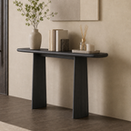Angled view of the dark console table's rounded top and broad tapered supports.