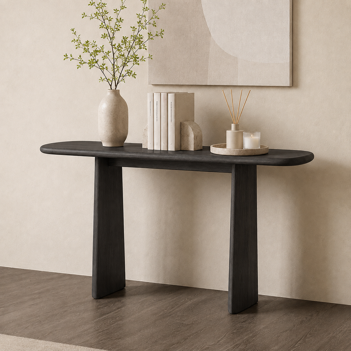 Dark narrow console table with a rounded top and two tapered panel legs, styled with books and a vase.