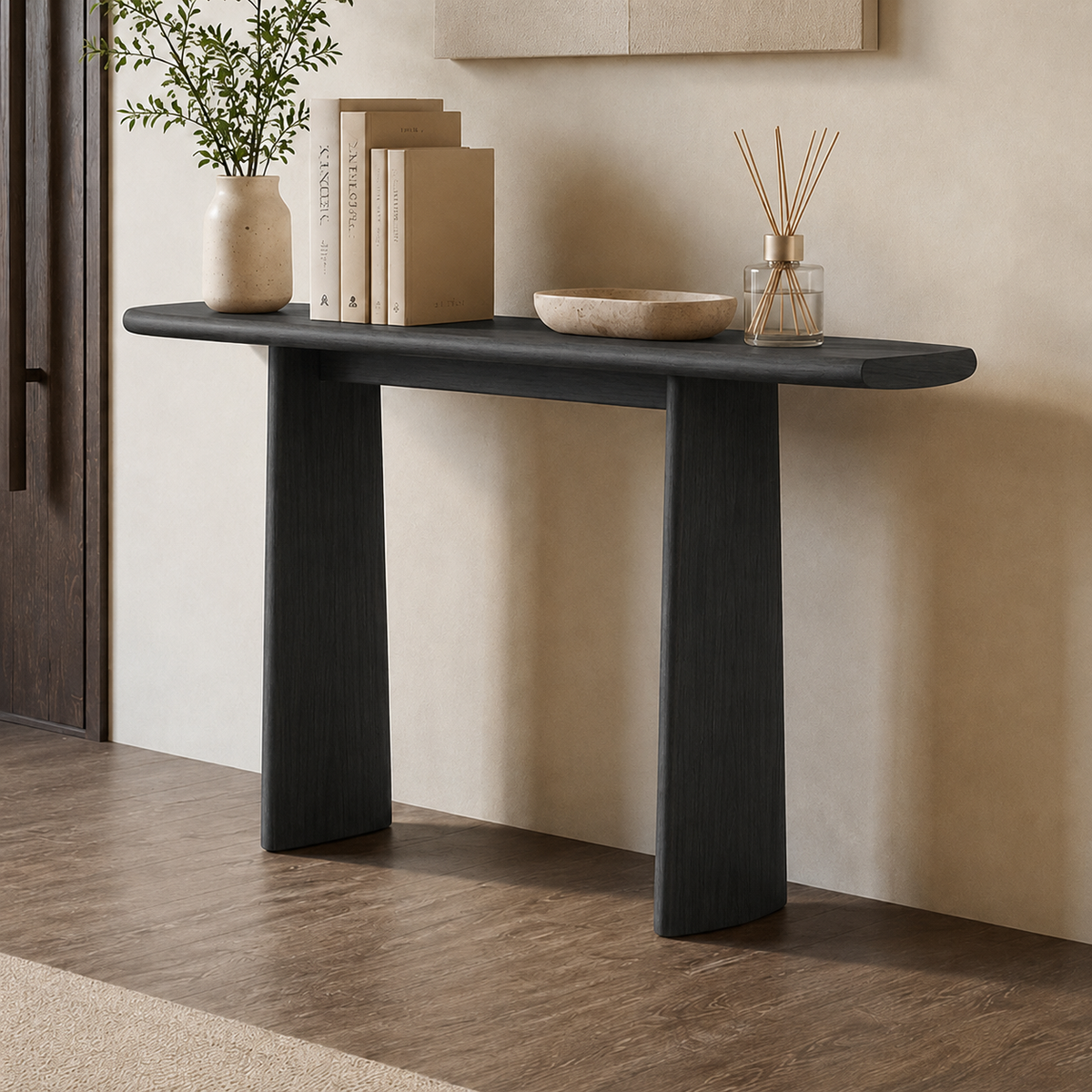 Dark wood-tone console table against a pale wall, with a long rounded top over two panel legs.