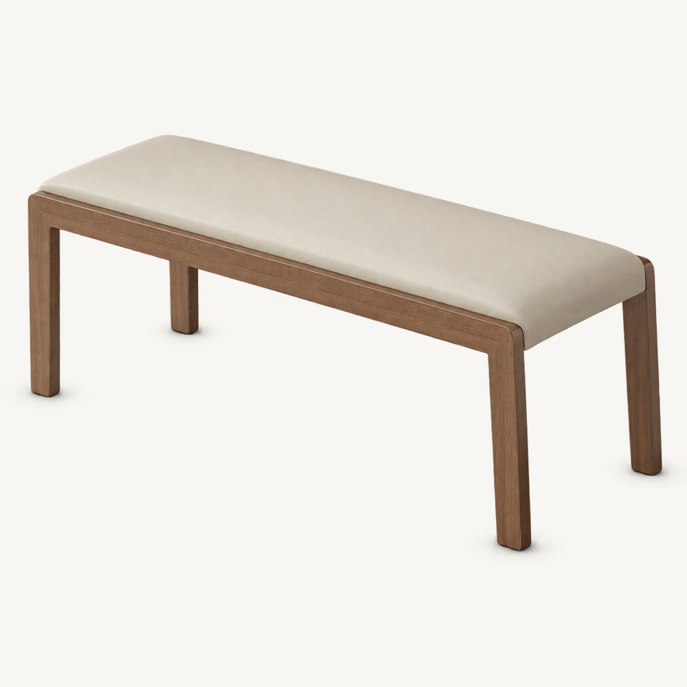 Cream upholstered bench with a gently rounded padded seat and four slim brown legs.