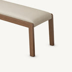 Close-up of the cream bench cushion and right corner of its brown frame.