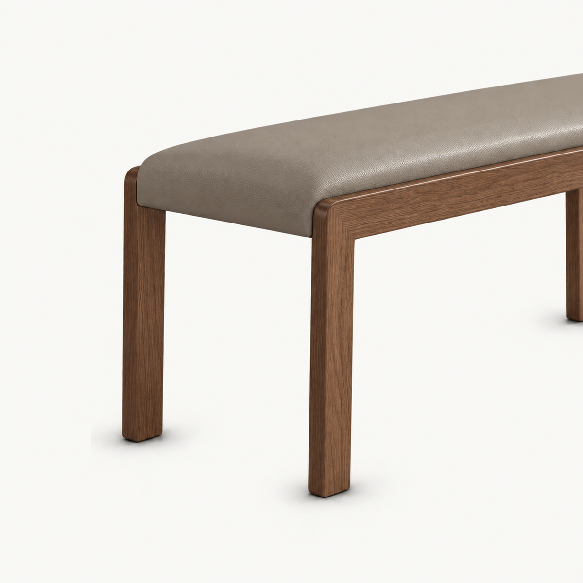 Angled detail of the taupe bench seat above two slim brown legs.
