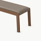 Close-up of the taupe bench cushion and right corner of its brown frame.