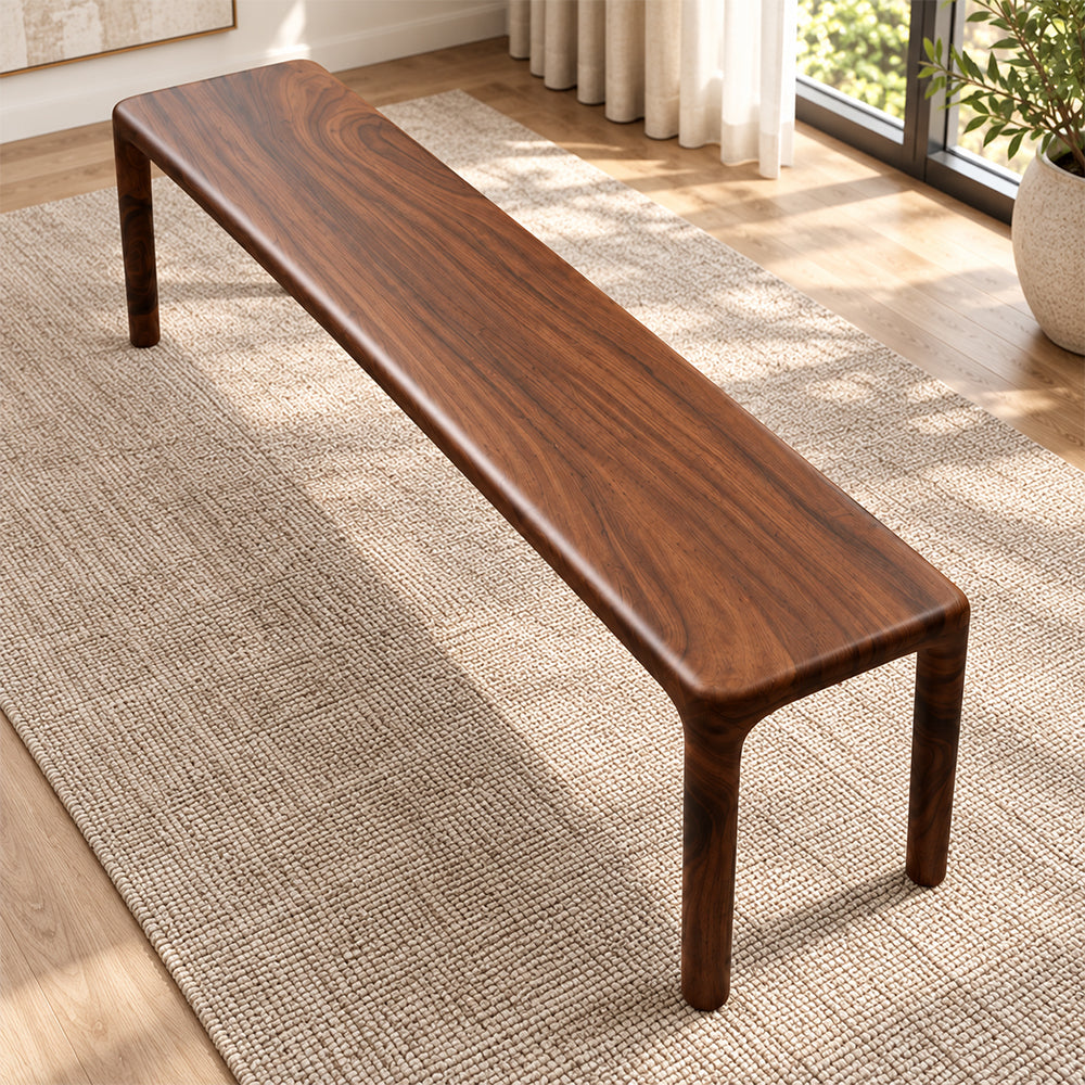 Overhead angled view of the brown bench's smooth narrow seat and rounded corners.