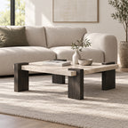 Angled view of the light speckled-top square coffee table beside a cream sofa.