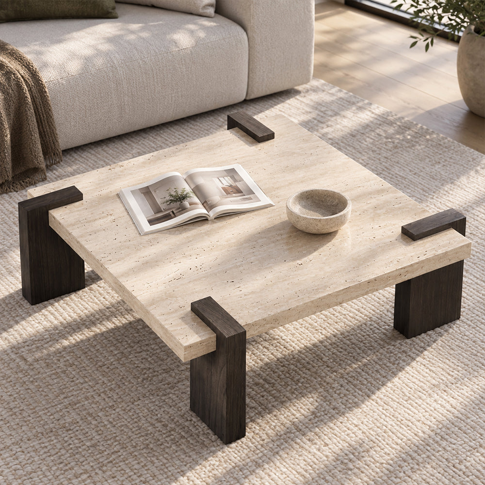 Square coffee table with a light speckled top and dark brown block legs extending over its edges, viewed from above.