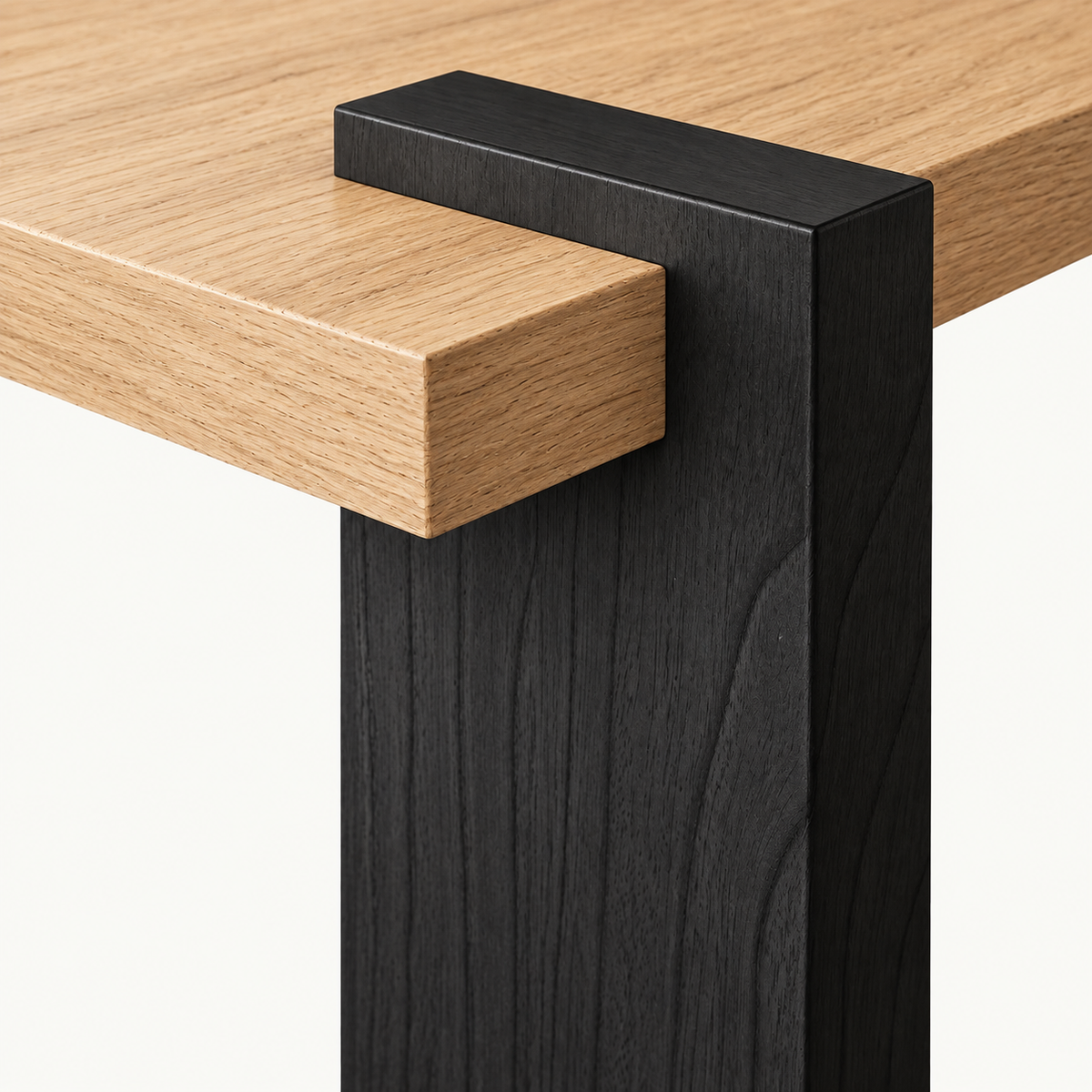 Close-up of the coffee table's black block leg and projecting light wood-grain tabletop corner.