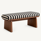 Long striped upholstered bench with a rounded cushion and two broad brown panel legs.