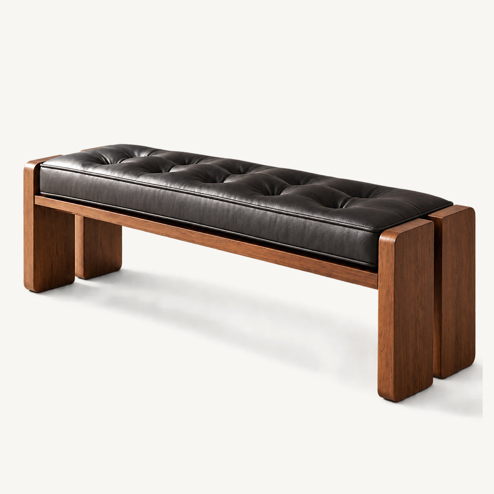 Black tufted upholstered bench with brown panel legs on a white background.