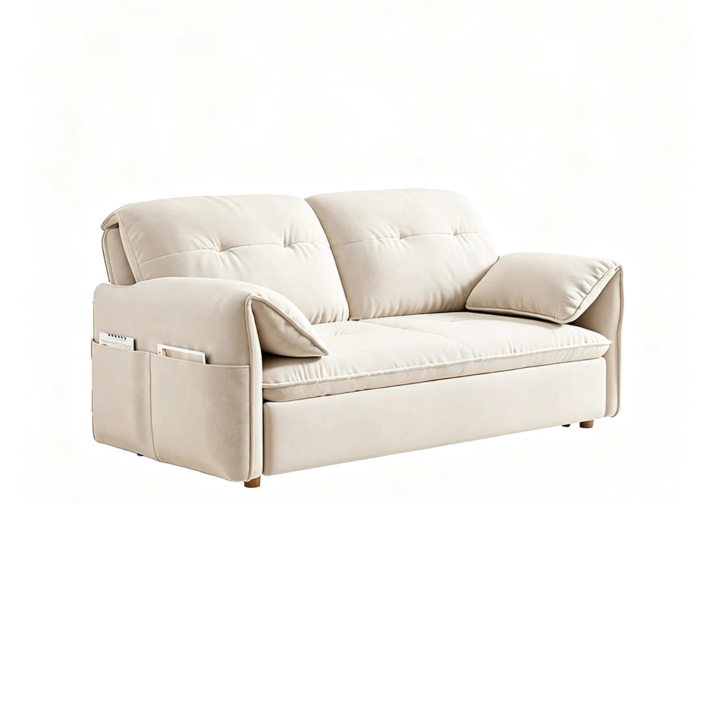 Cream sofa bed in sofa form with tufted back cushions, arm pillows and gold-tone feet on a white background.
