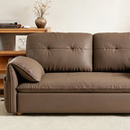 Close-up of the taupe-brown sofa bed's front seat edge and padded arm cushion.