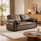 Opposite room view of the taupe-brown sofa bed with padded arm cushions and a side pocket.