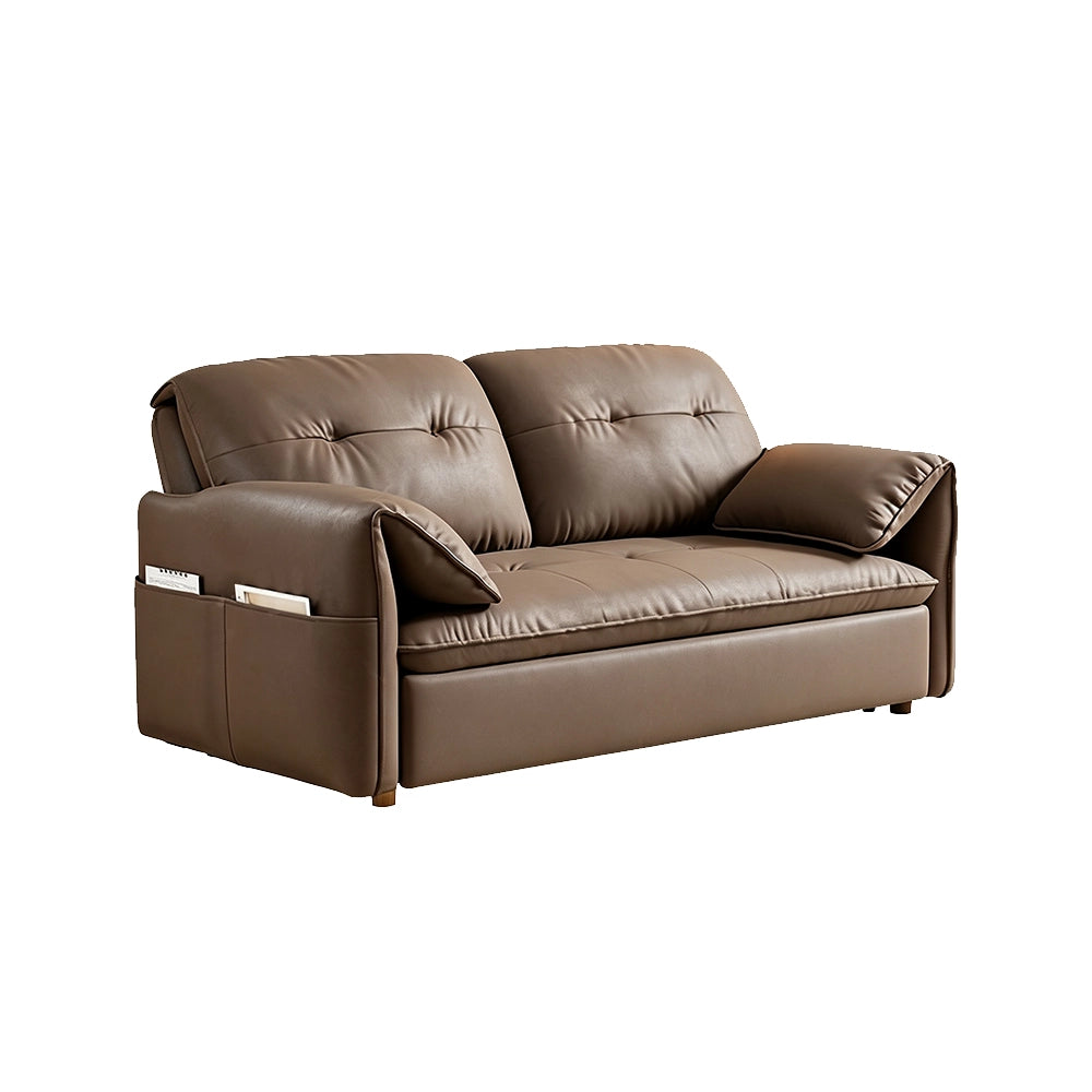 Taupe-brown sofa bed in sofa form with curved arms, loose pillows and gold-tone feet on a white background.