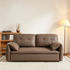 Taupe-brown sofa bed in sofa form with tufted back cushions, loose arm pillows and gold-tone feet.