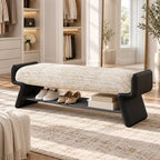 cream upholstered shoe bench with black side supports, shown with shoes and boxes on its lower rack.