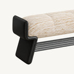 Close-up of the cream bench cushion, raised black end support and lower shoe rack.