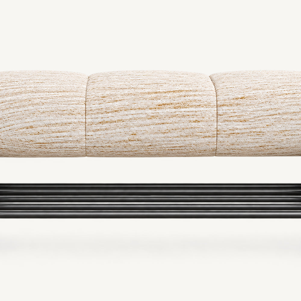 Front detail of the cream upholstered bench seat and parallel bars of its black lower rack.