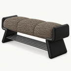 dark taupe textured bench cushion between raised black ends, above angled side supports and a slatted shoe rack.