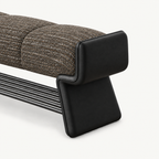 Angled close-up of the dark taupe bench cushion and shaped black side support.