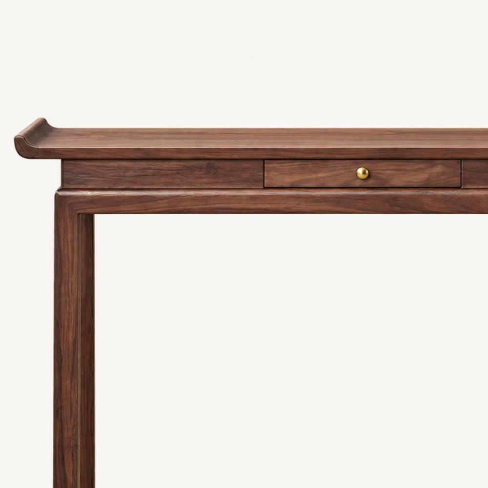 Front detail of the brown console table's upturned end and central drawer with a round knob.