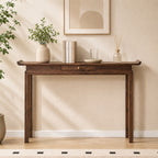 Brown console table with upturned tabletop ends, a small center drawer and four slender legs.