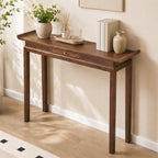 Angled view of the brown console table's narrow top, upturned ends and center drawer.