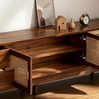 TV cabinet with woven-panel center doors open to reveal interior storage shelves.