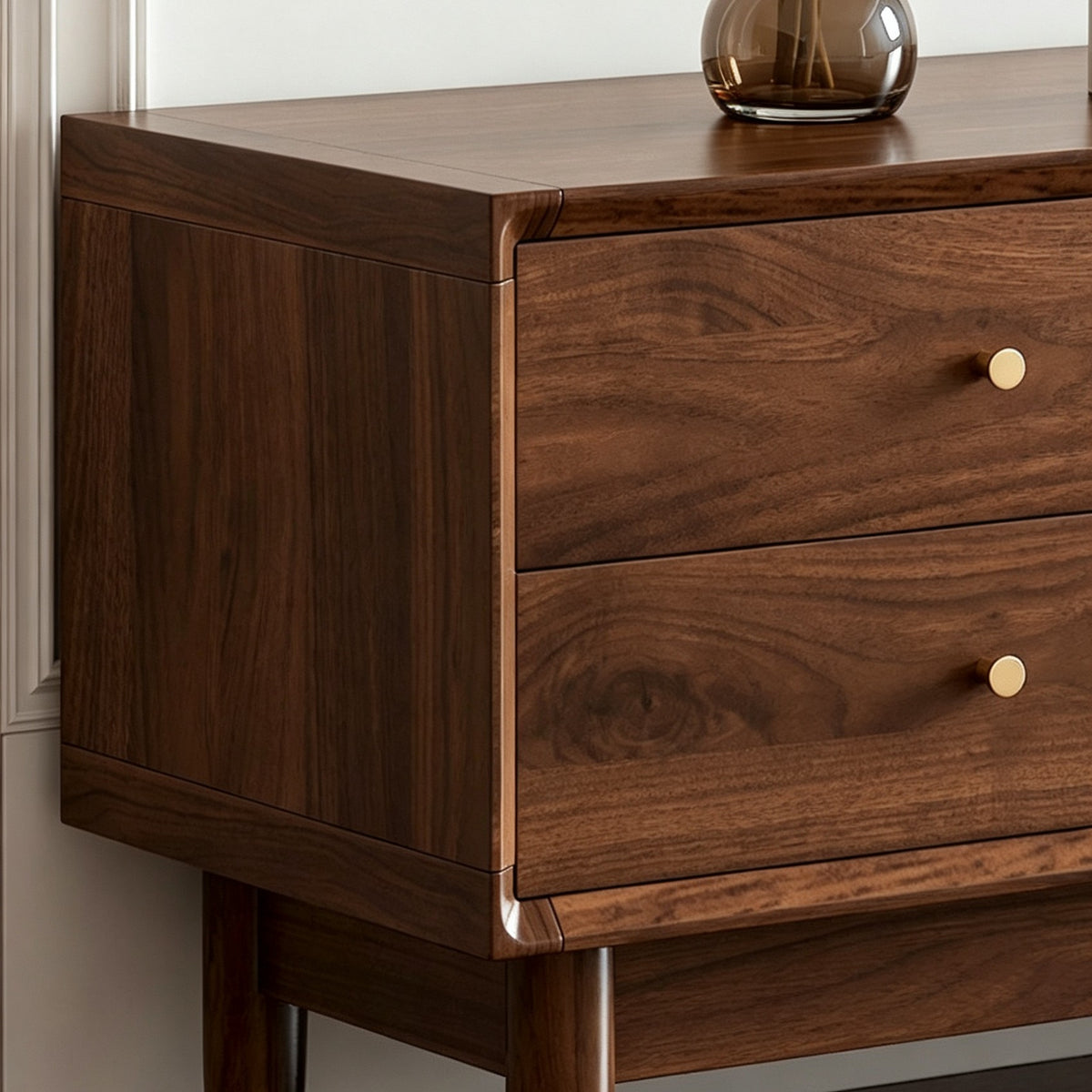 Close-up of the TV cabinet's wood-grain drawer fronts, small round knobs and rounded corner frame.