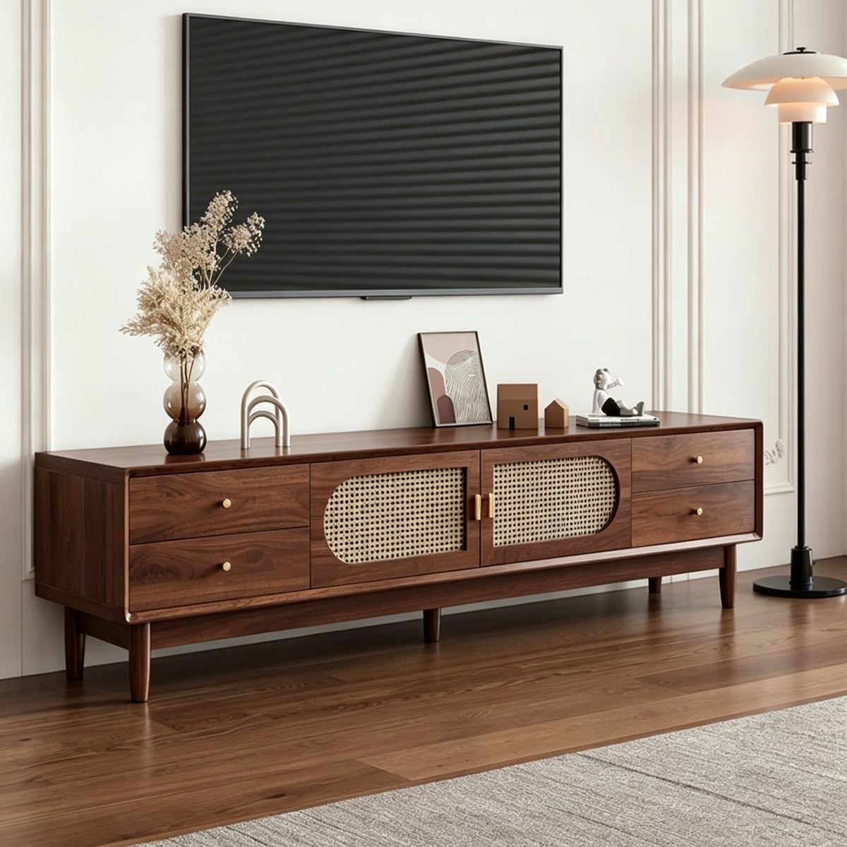 Brown TV cabinet with pale woven-pattern door inserts, side drawers and tapered legs beneath a television.