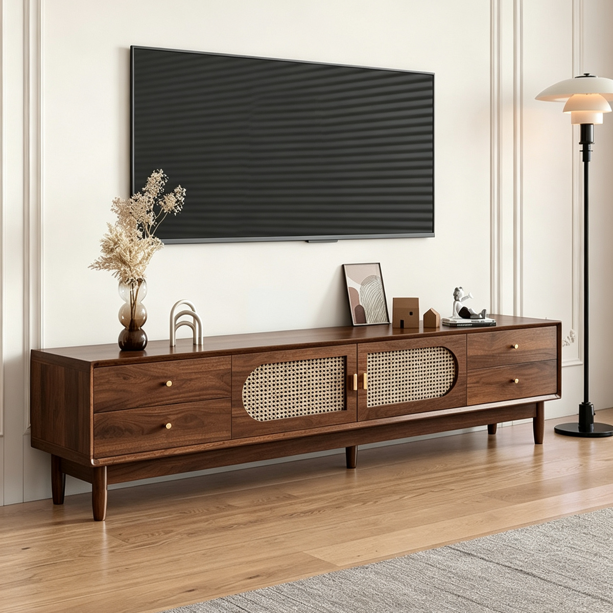 Long brown TV cabinet with woven-pattern door inserts and side drawers below a television.